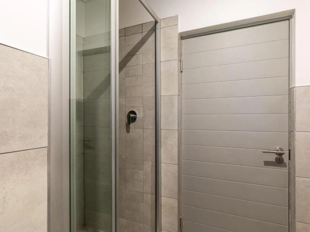 Modern bathroom with walk-in shower enclosure and neutral tile finishes