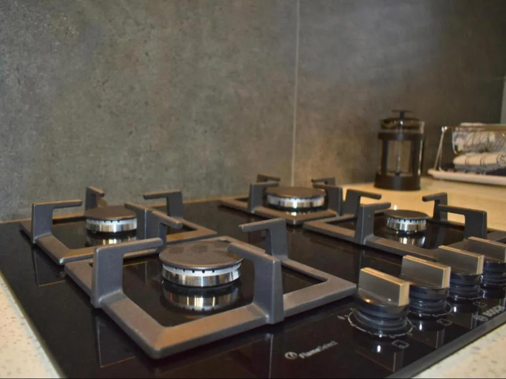Modern gas cooktop with stainless steel burners and sleek black surface