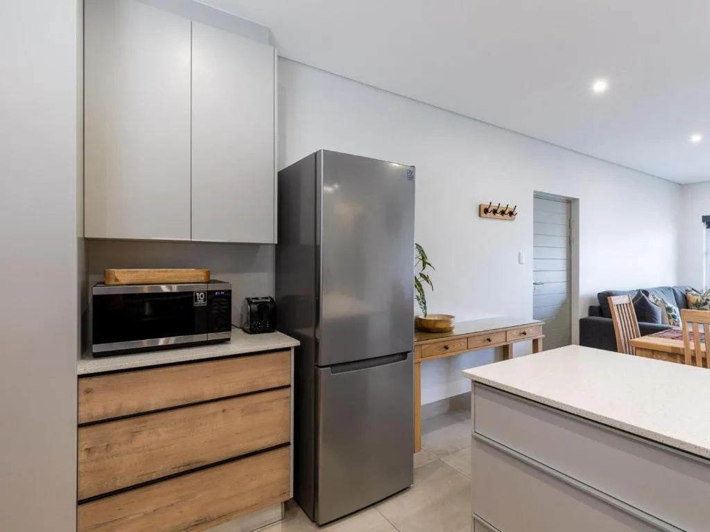 Modern kitchen with stainless steel appliances and white cabinetry