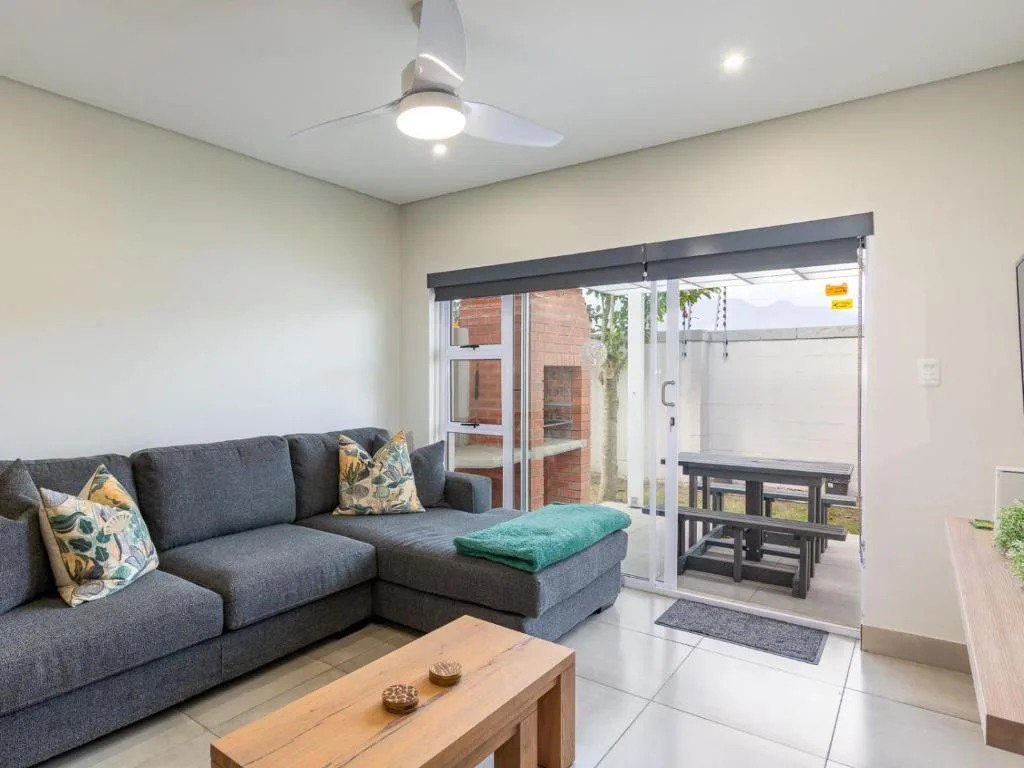 Modern lounge with gray sectional sofa and wooden coffee table