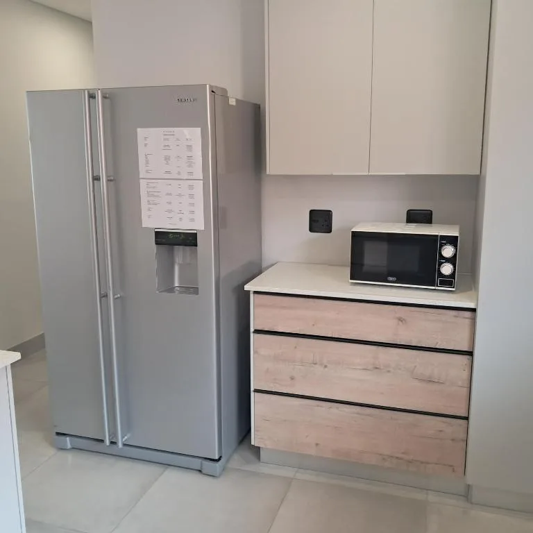 Modern kitchen with stainless steel refrigerator and microwave appliances