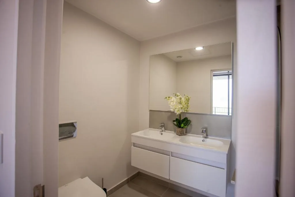 Modern bathroom with double vanity sink and large mirror
