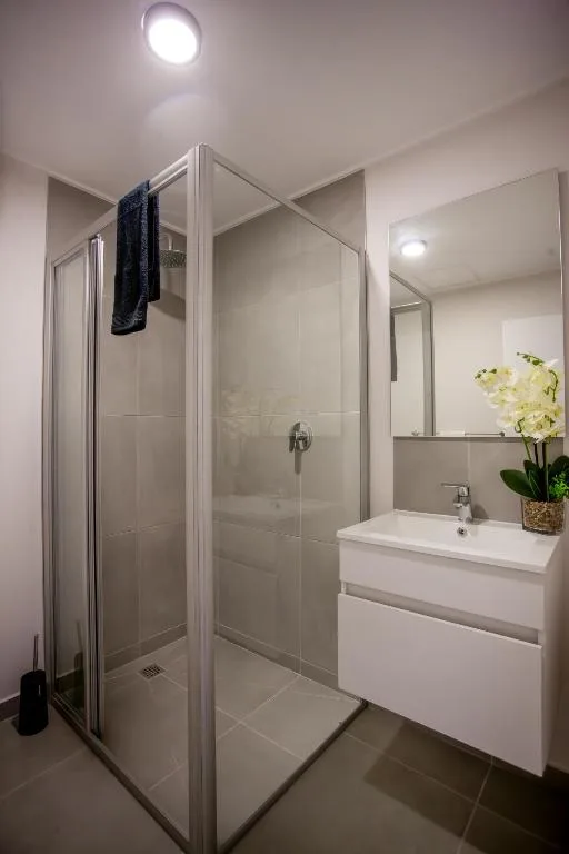 Modern bathroom with glass shower enclosure and white vanity sink