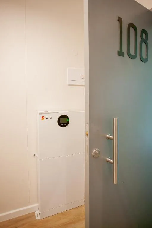 Modern heating unit with digital display mounted on white wall