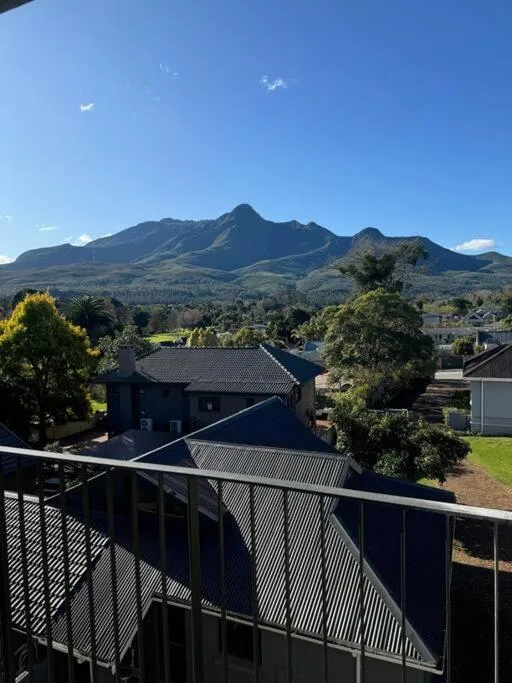 Mountain peak and valley landscape vista from property deck railing