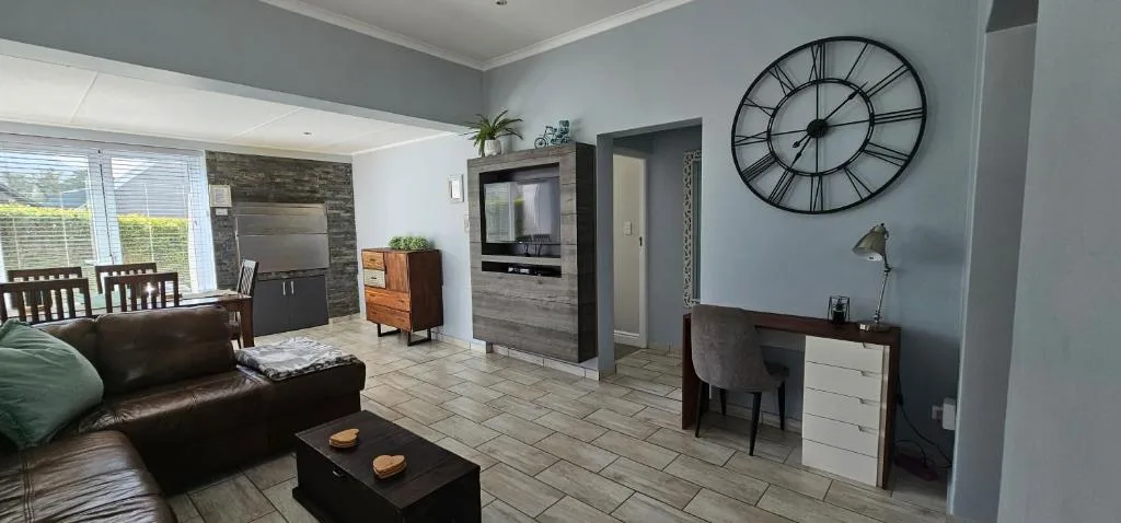 Modern lounge with leather sofa, TV, and contemporary decor