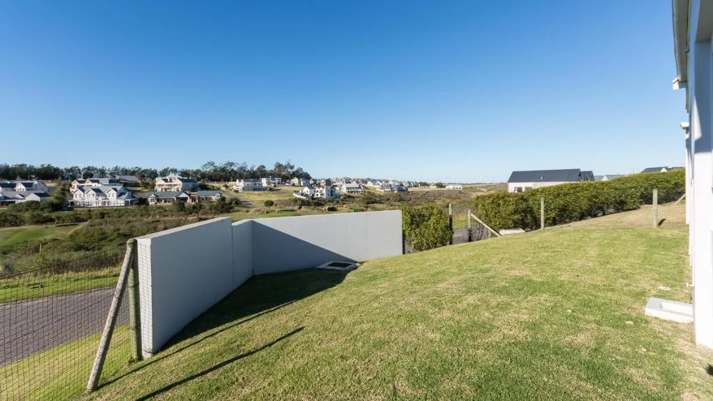 Expansive countryside landscape with neighboring homes and green rolling hills