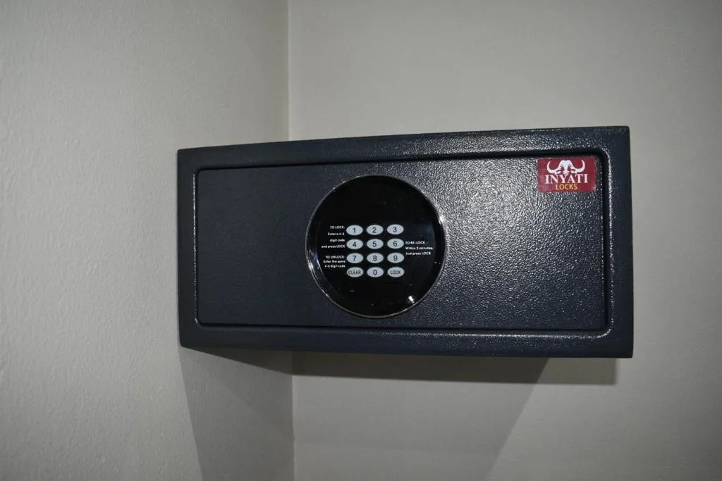 Digital electronic safe mounted on white interior wall