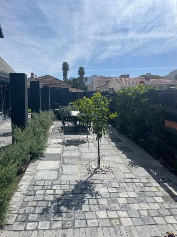 Paved outdoor patio with dining table and landscaped garden area