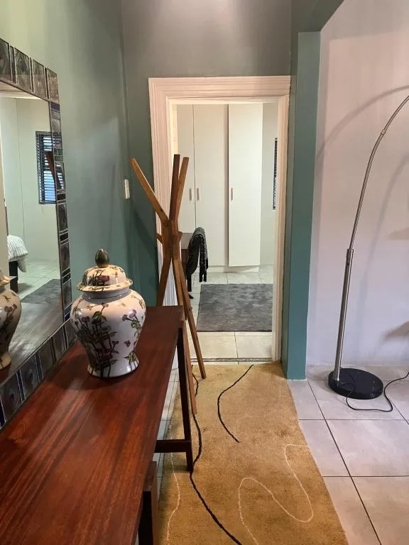 Modern hallway with decorative wooden stand and ceramic vase accent piece