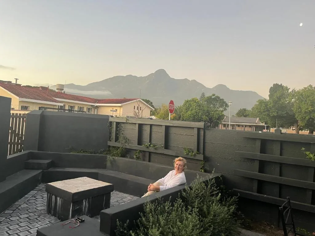 Rooftop patio with seating and mountain views at sunset