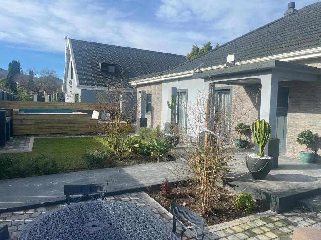 Modern white brick house with contemporary deck and manicured garden space
