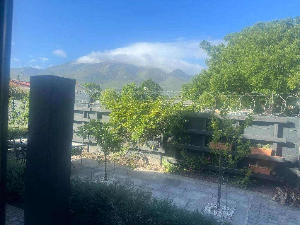 Mountain vista with lush green slopes visible from property garden area