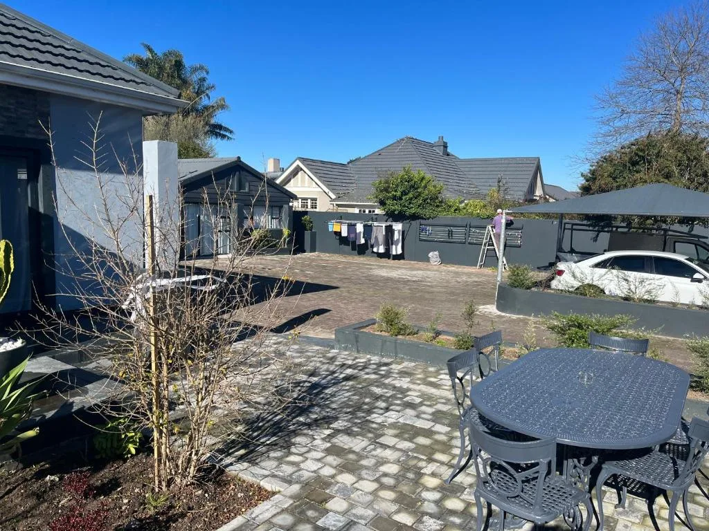 Outdoor patio area with dining table and modern architectural design