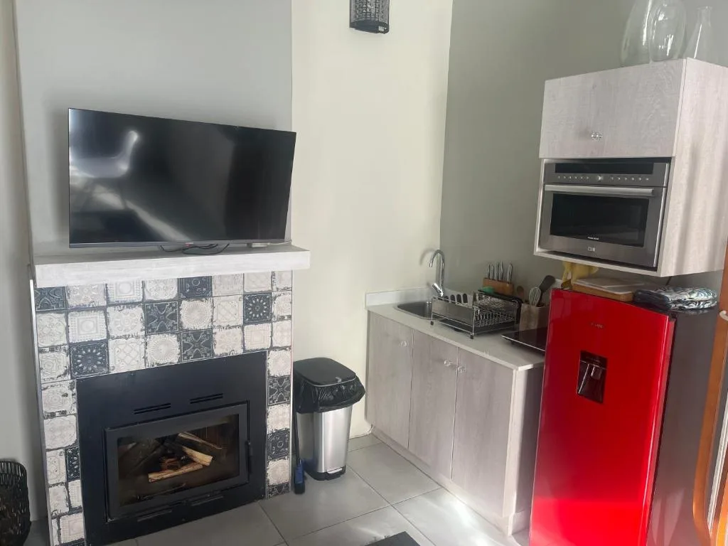 Modern kitchen with red fridge, gas stove, and built-in microwave oven