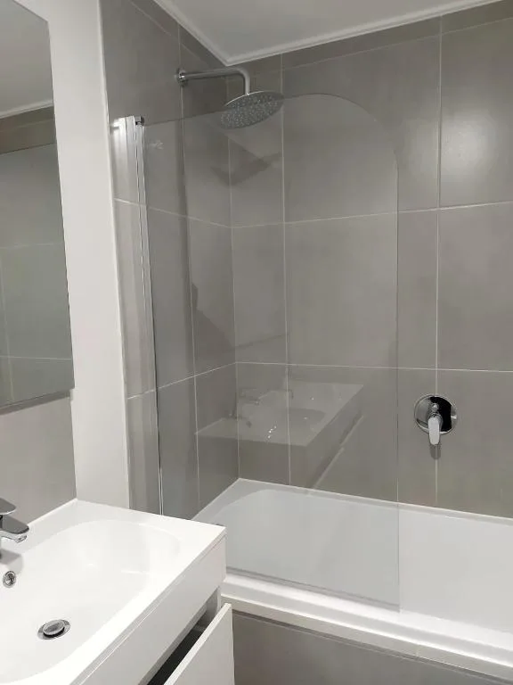 Modern bathroom with glass shower enclosure and white vanity sink
