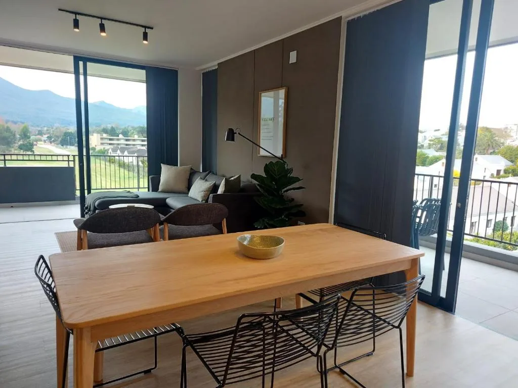 Modern dining table with mountain views through floor-to-ceiling windows