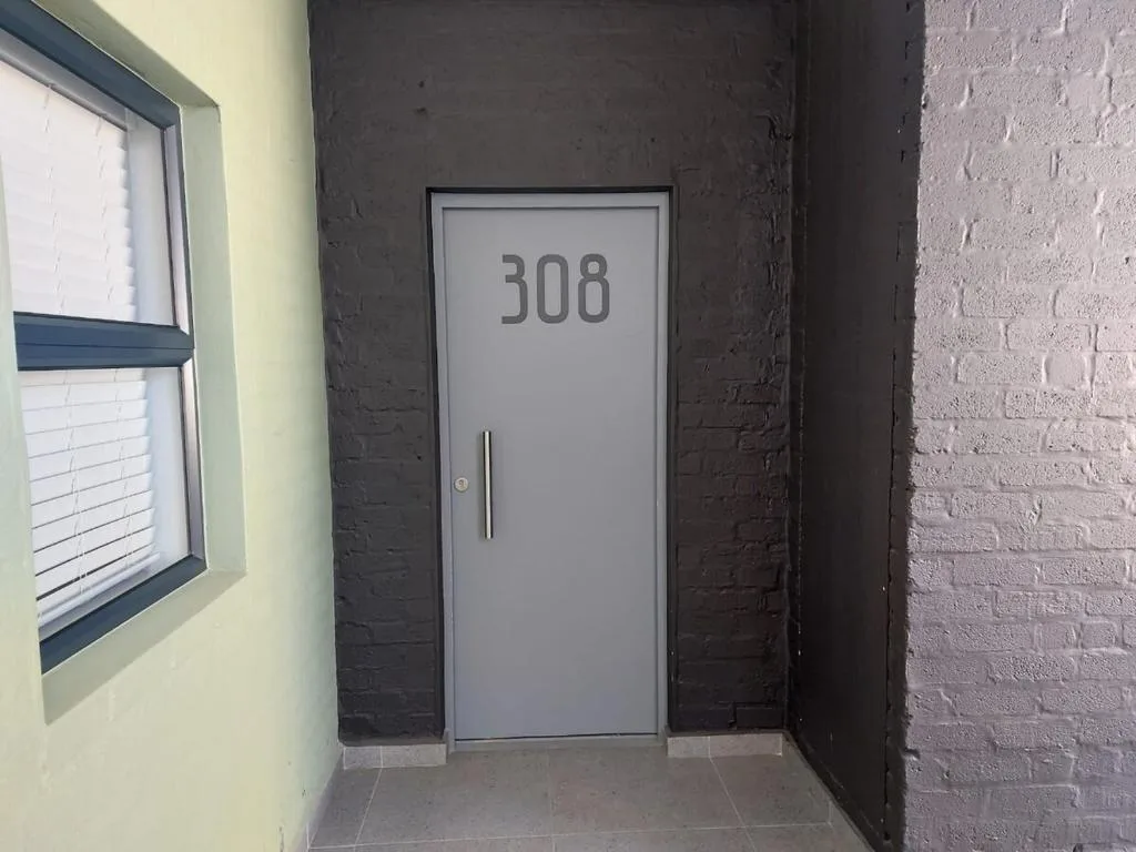 Modern apartment entrance door numbered 308 with contemporary styling