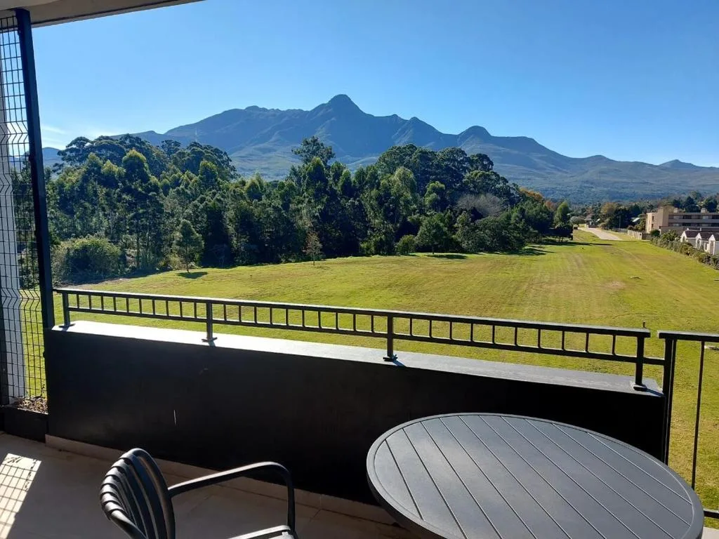 Mountain vista and manicured gardens viewed from covered deck