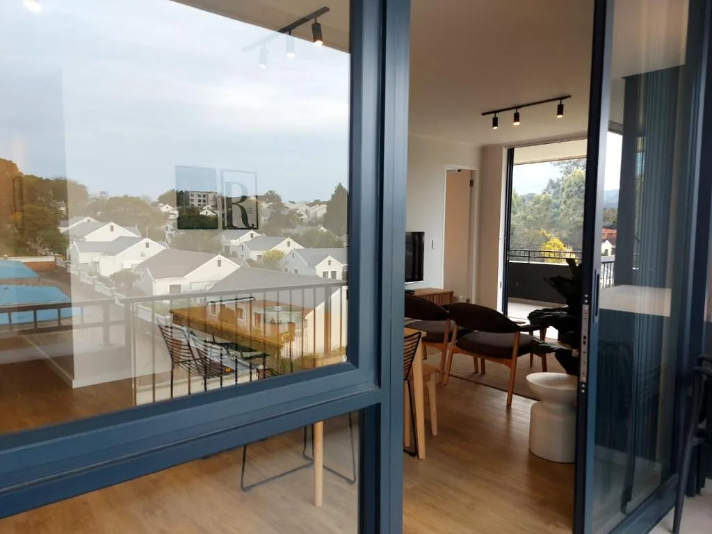 Expansive town views from modern apartment with white houses below