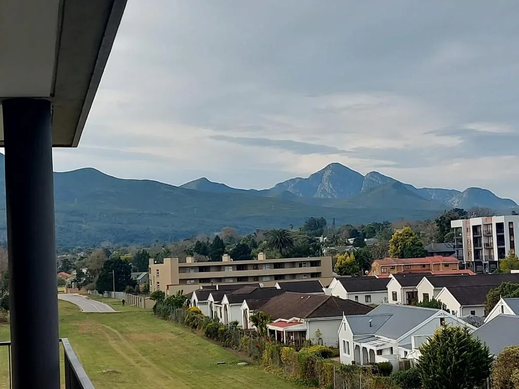 Mountain range and village landscape visible from property balcony