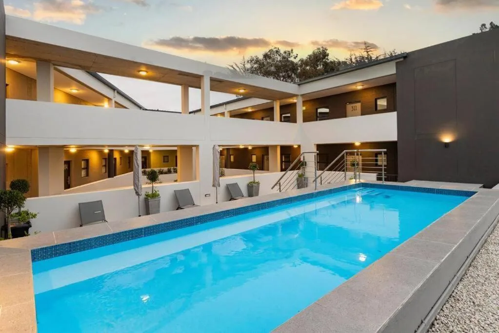 Modern resort-style swimming pool with crystal-clear blue water and surrounding architecture