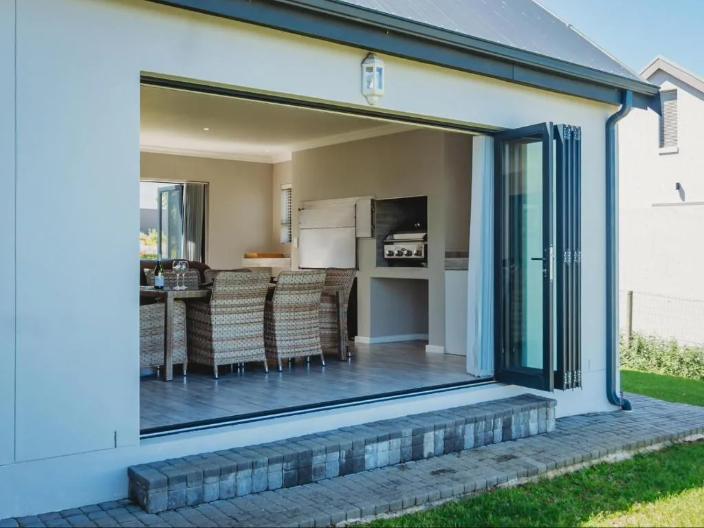Modern patio with sliding doors opening to furnished interior seating area