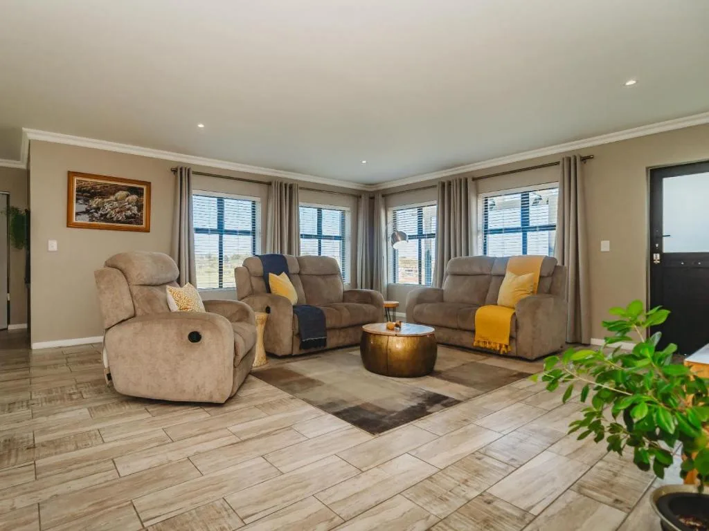 Spacious lounge with reclining chairs, mountain views through large windows