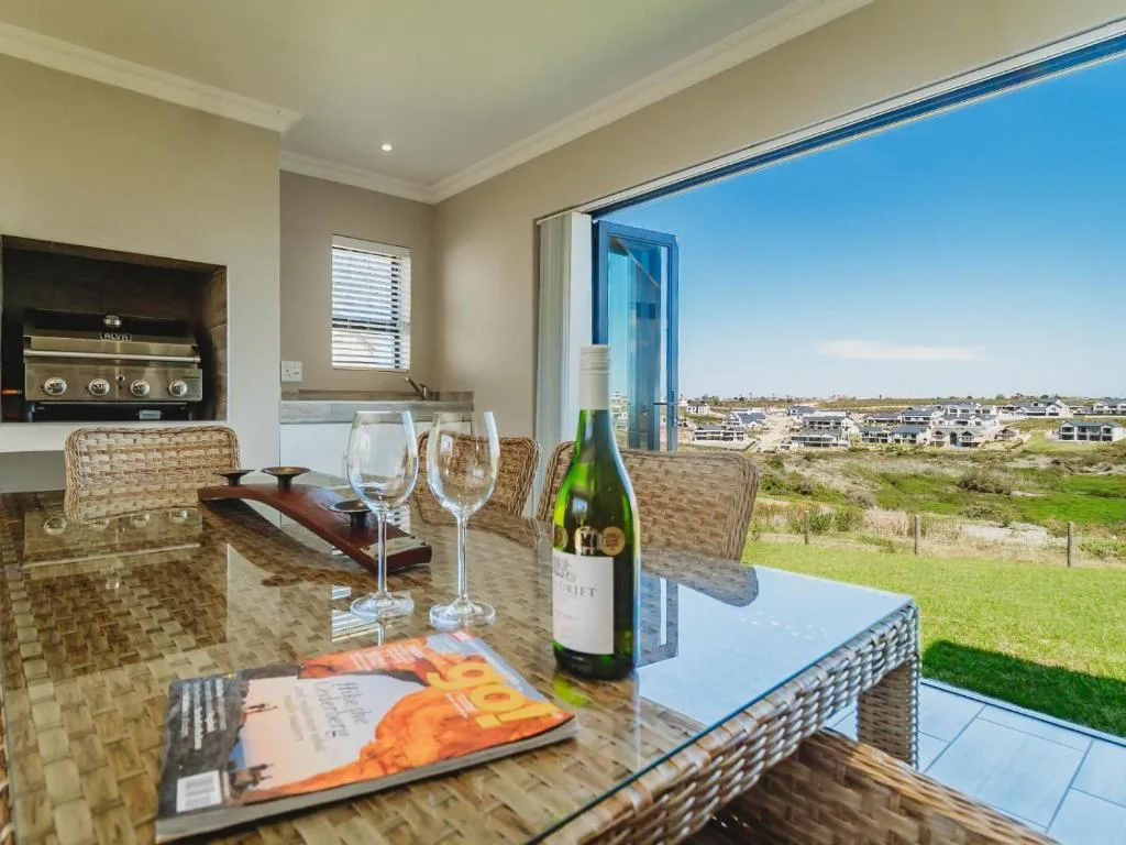 Scenic view of golf estate and countryside through large glass doors