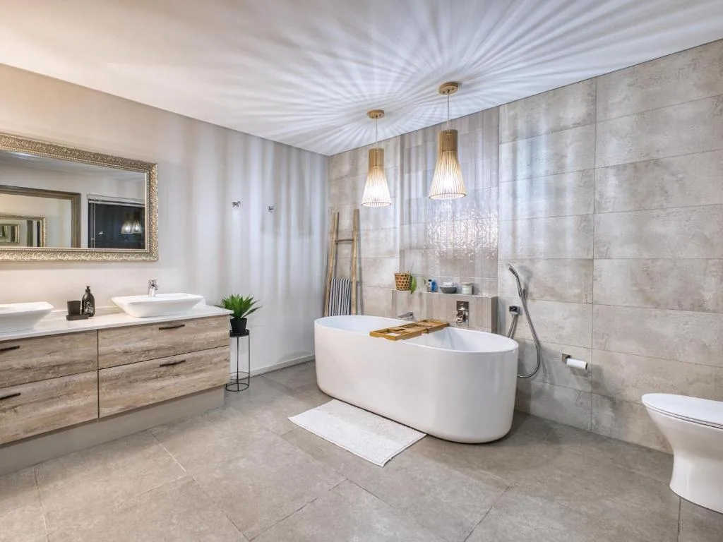 Luxury modern bathroom with freestanding white tub and double vanity