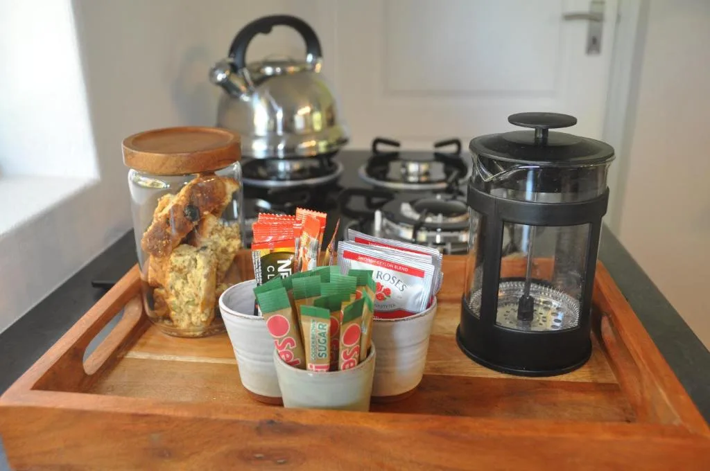 Welcome tray with tea, coffee, cookies, and kettle in kitchen area