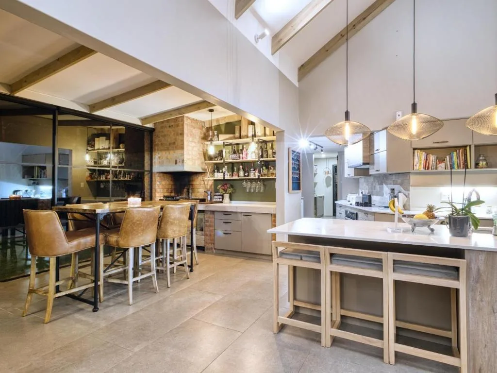 Modern open-plan kitchen with island, pendant lights, and bar seating
