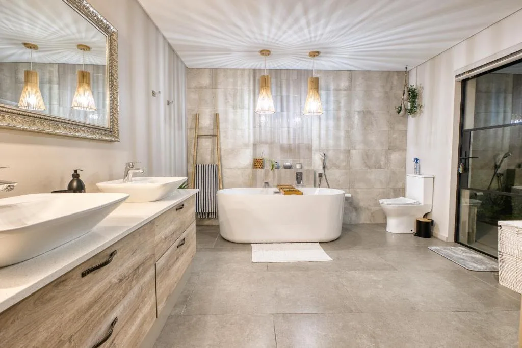 Luxurious modern bathroom with freestanding tub, dual vanity, and pendant lighting