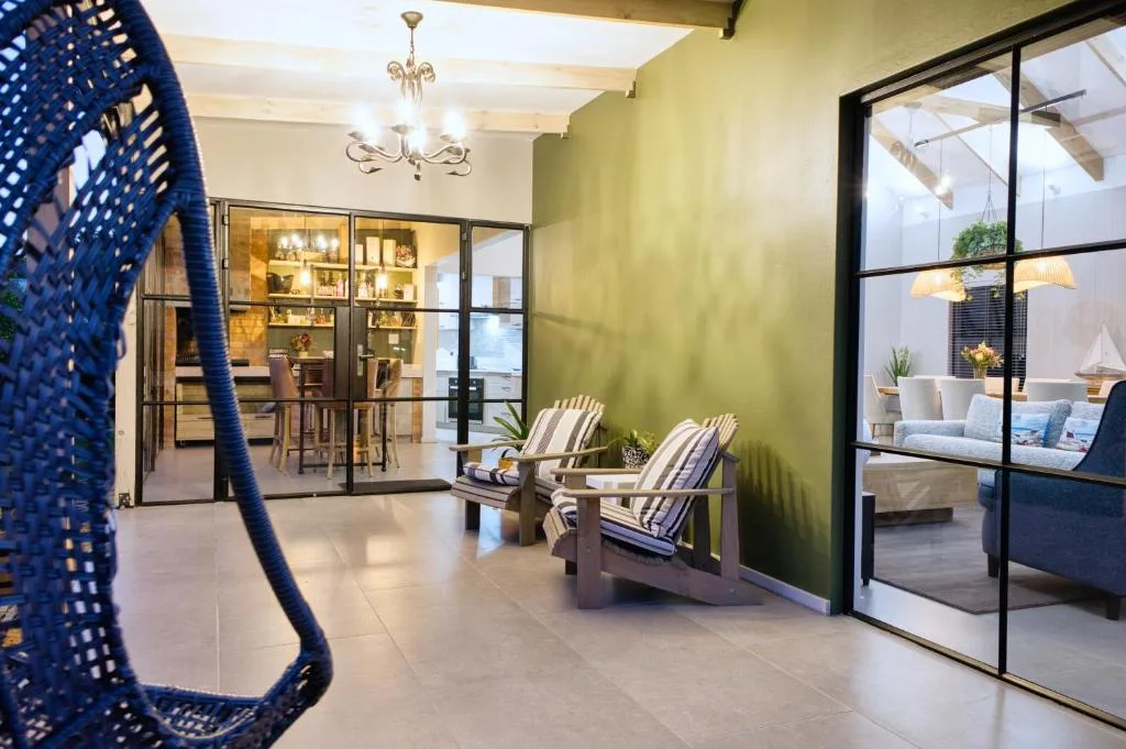Covered patio with Adirondack chairs and modern glass doors