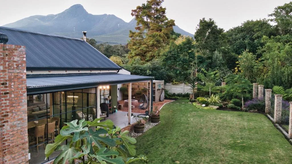 Modern villa exterior with mountain views, manicured garden and contemporary architecture