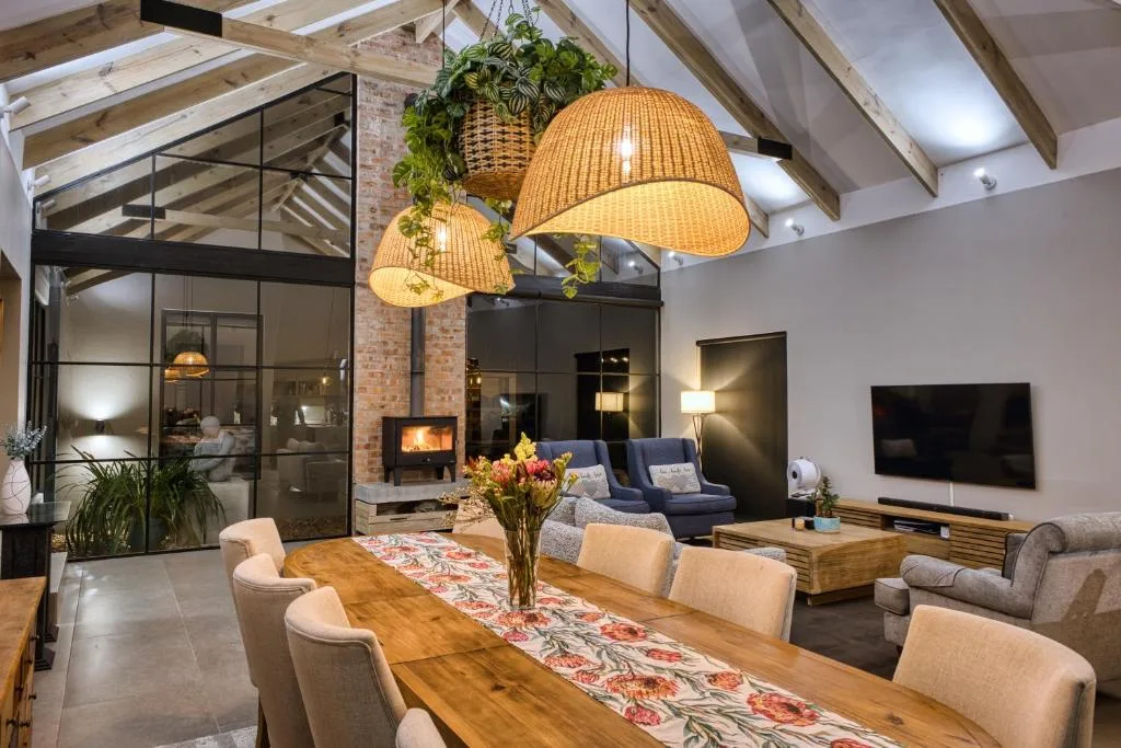 Open-plan lounge with fireplace, pendant lights, and comfortable seating arrangement