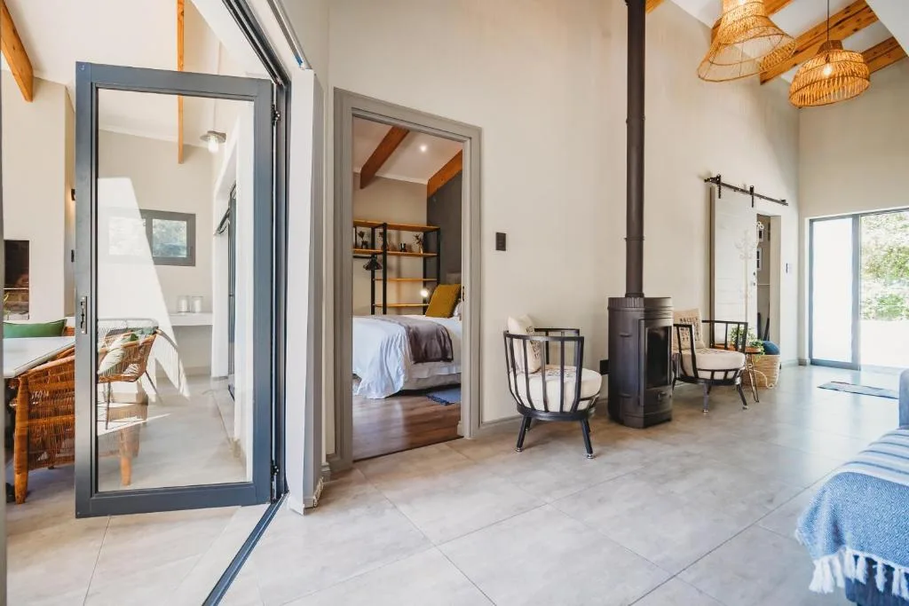 Modern open-plan living space with wood stove and contemporary furnishings