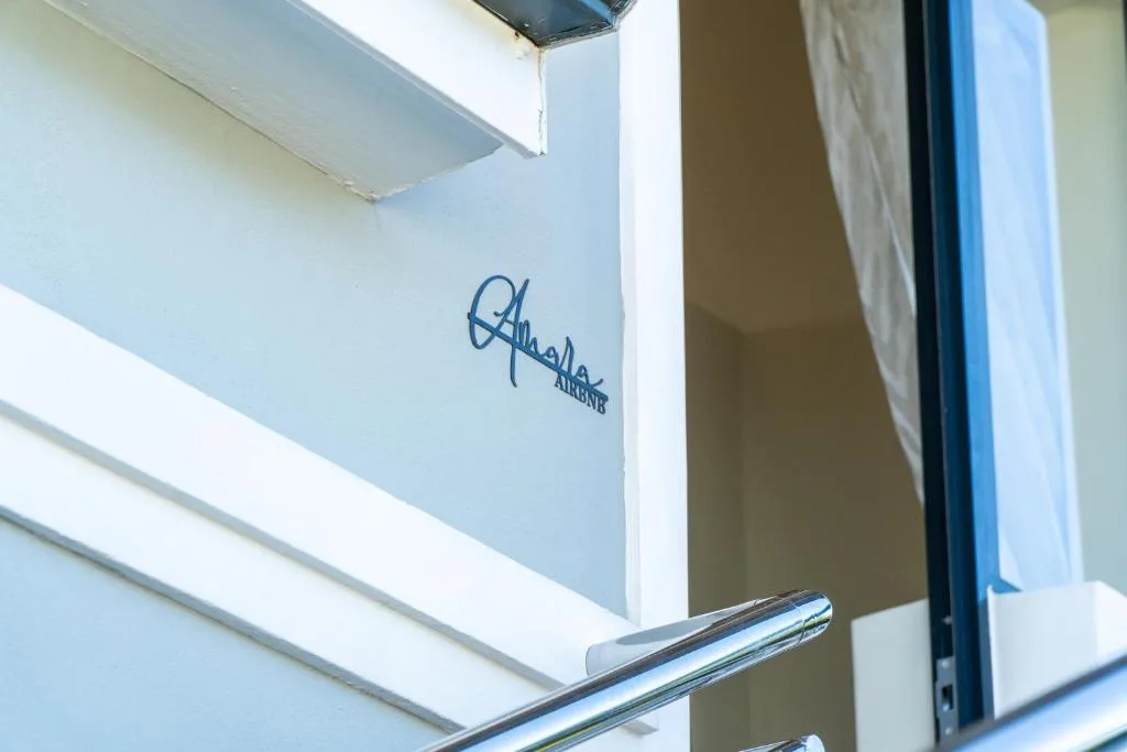 Close-up of Amara property signage on white building exterior