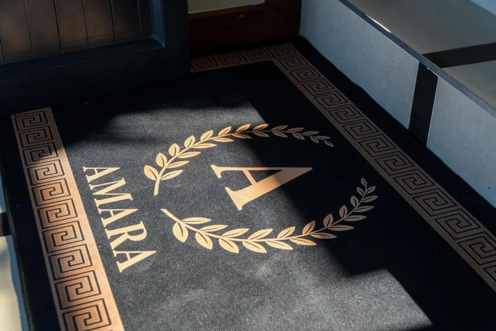 Elegant entrance doormat with Amara branding and decorative laurel design
