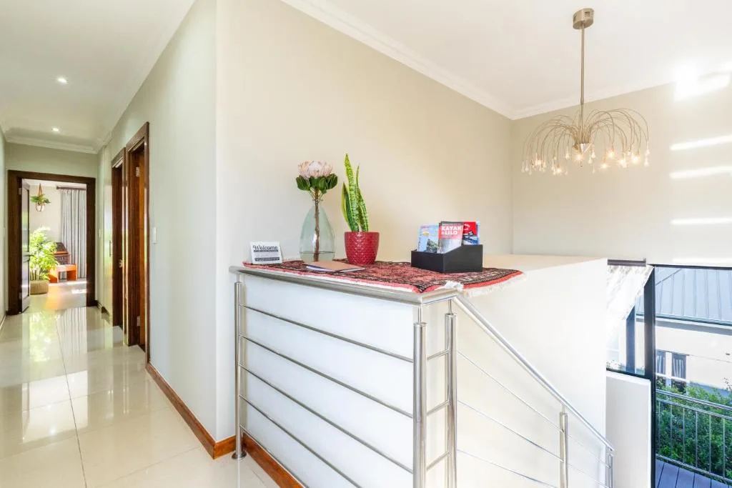 Modern reception desk with flowers, plants, and welcome amenities displayed