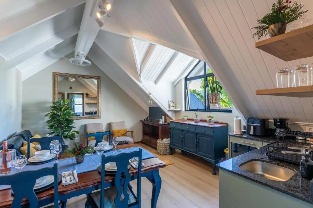 Open-plan lounge with blue dining table and comfortable seating area