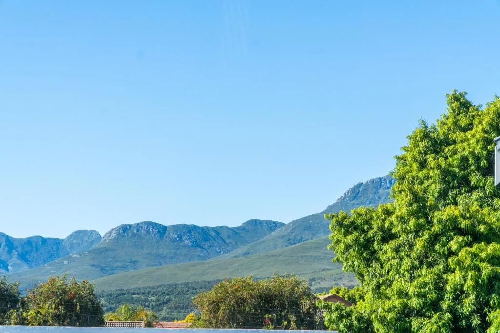 Mountain landscape view with green vegetation and clear blue sky