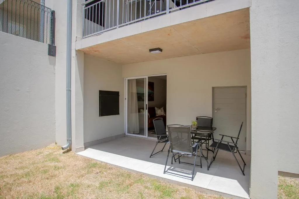 Covered patio with outdoor seating chairs and glass sliding doors