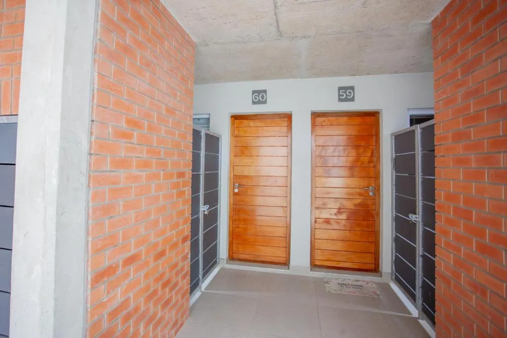 Red brick building exterior with wooden doors numbered 59 and 60