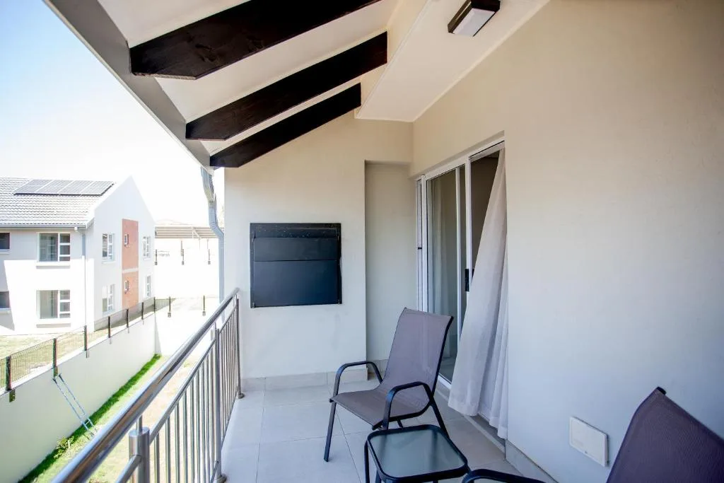Modern balcony with contemporary shade structure and lounge seating