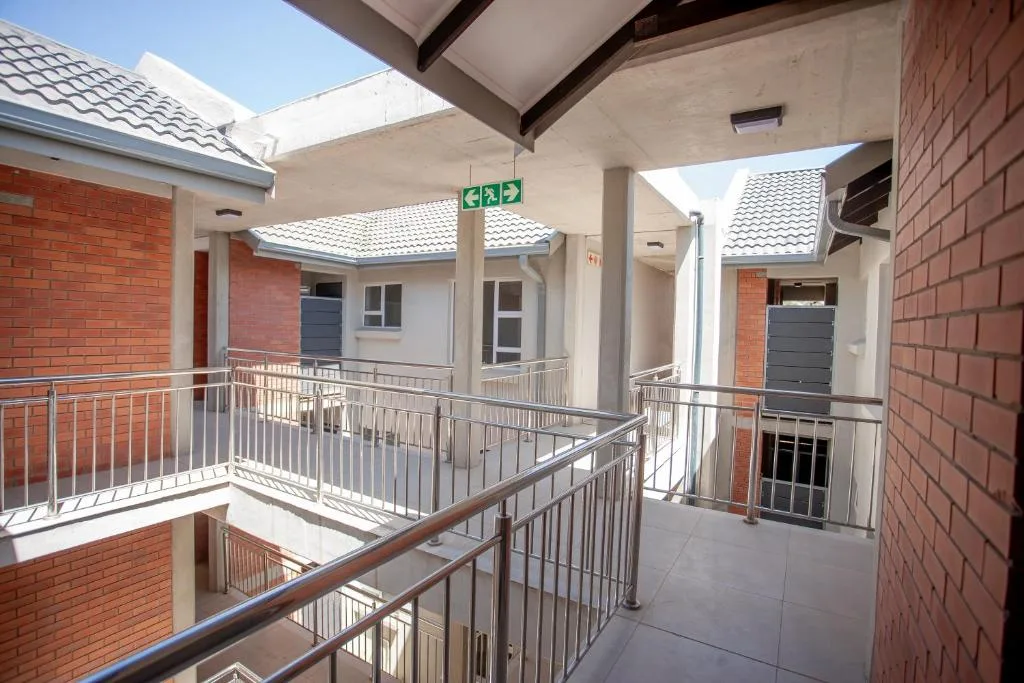 Modern apartment building courtyard with brick facades and metal railings