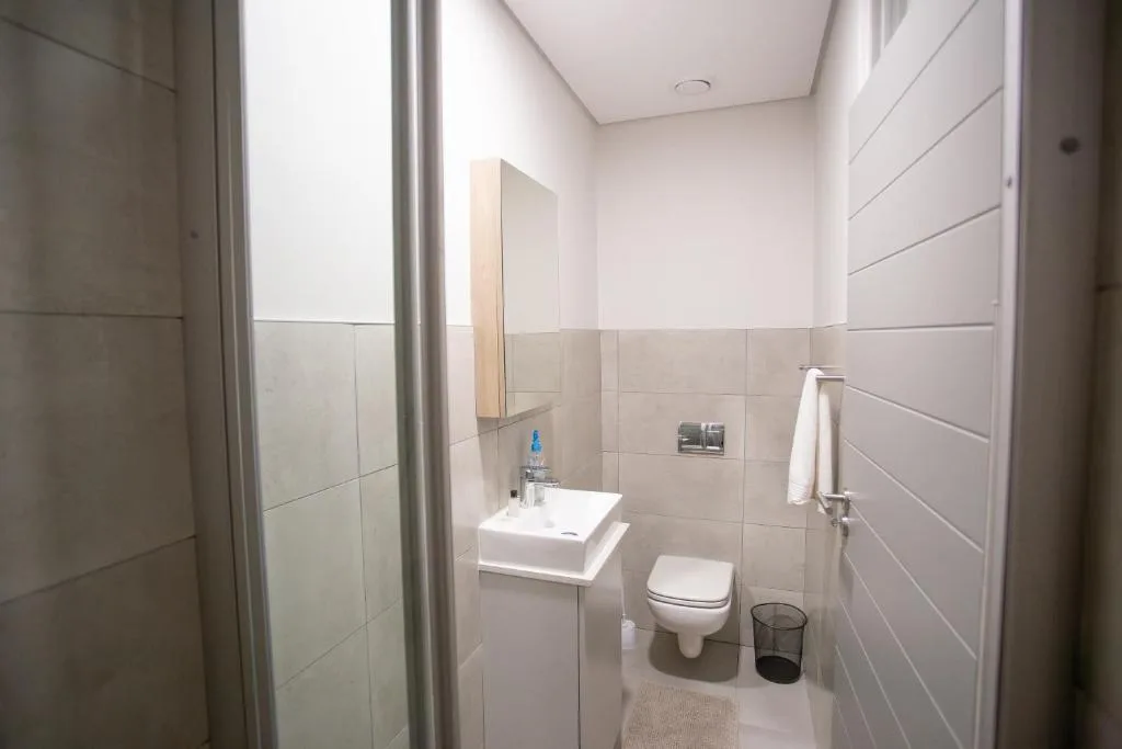 Clean modern bathroom with shower, vanity sink, and toilet fixtures