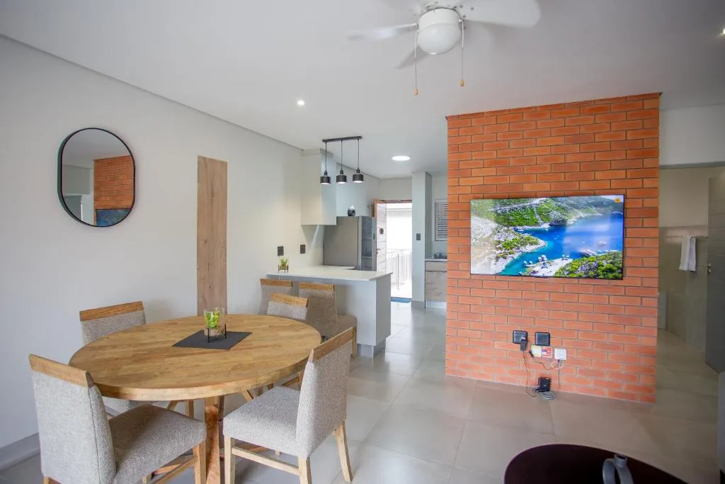 Open-plan dining area with wooden oval table and upholstered chairs