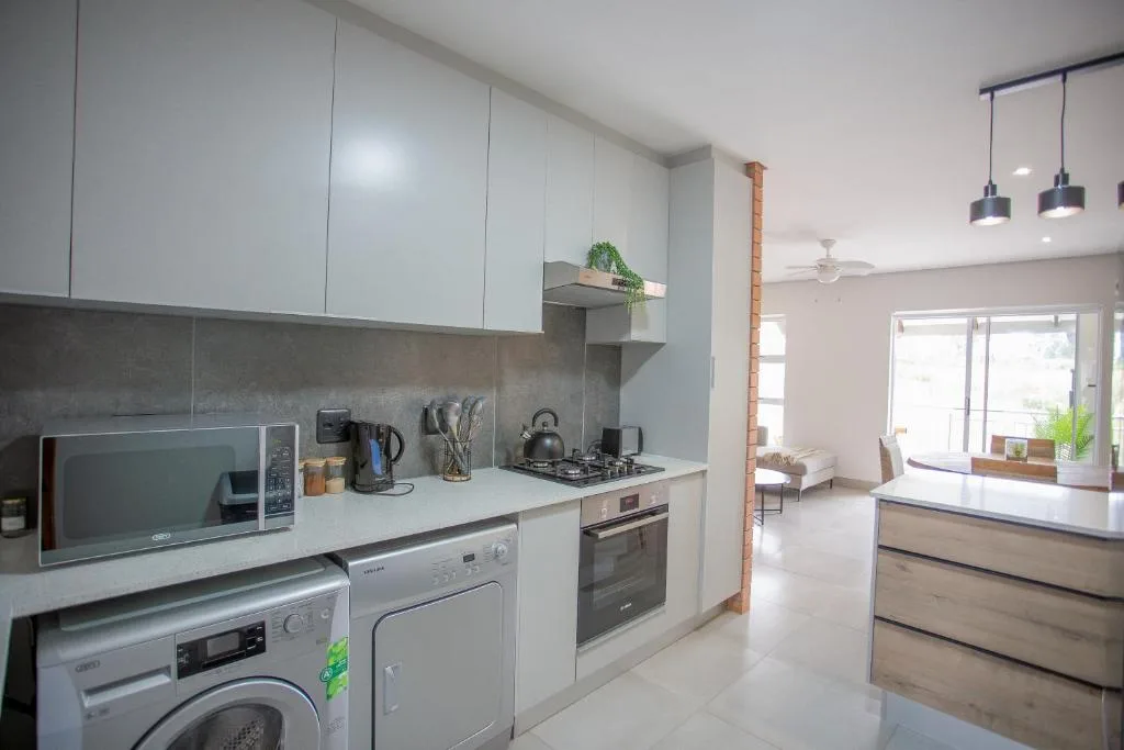 Modern kitchen with white cabinetry, gas stove, and integrated appliances