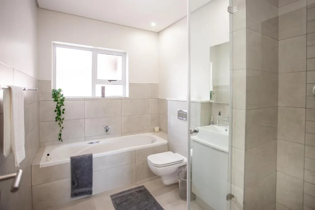 Modern bathroom with bathtub, toilet, shower enclosure and vanity